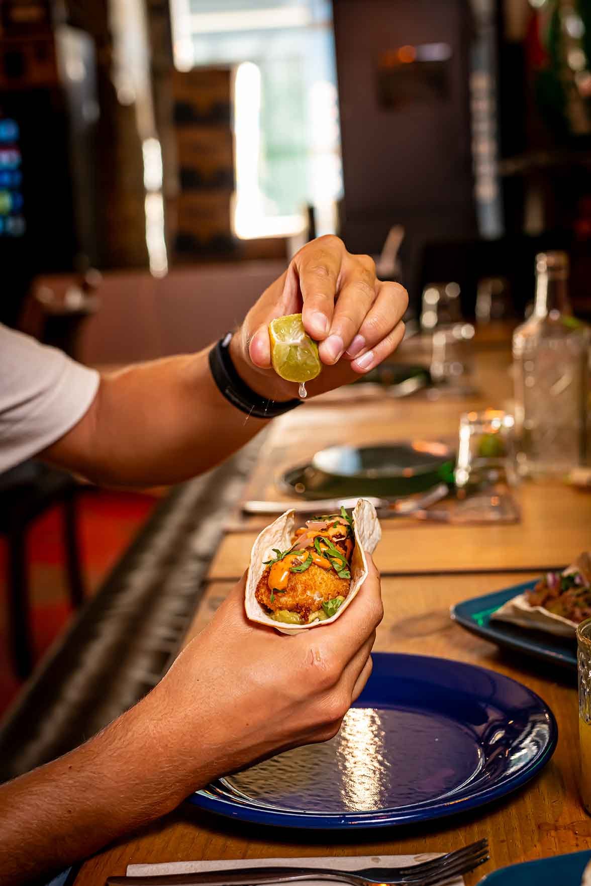 Squeezing lime over a fresh fish taco