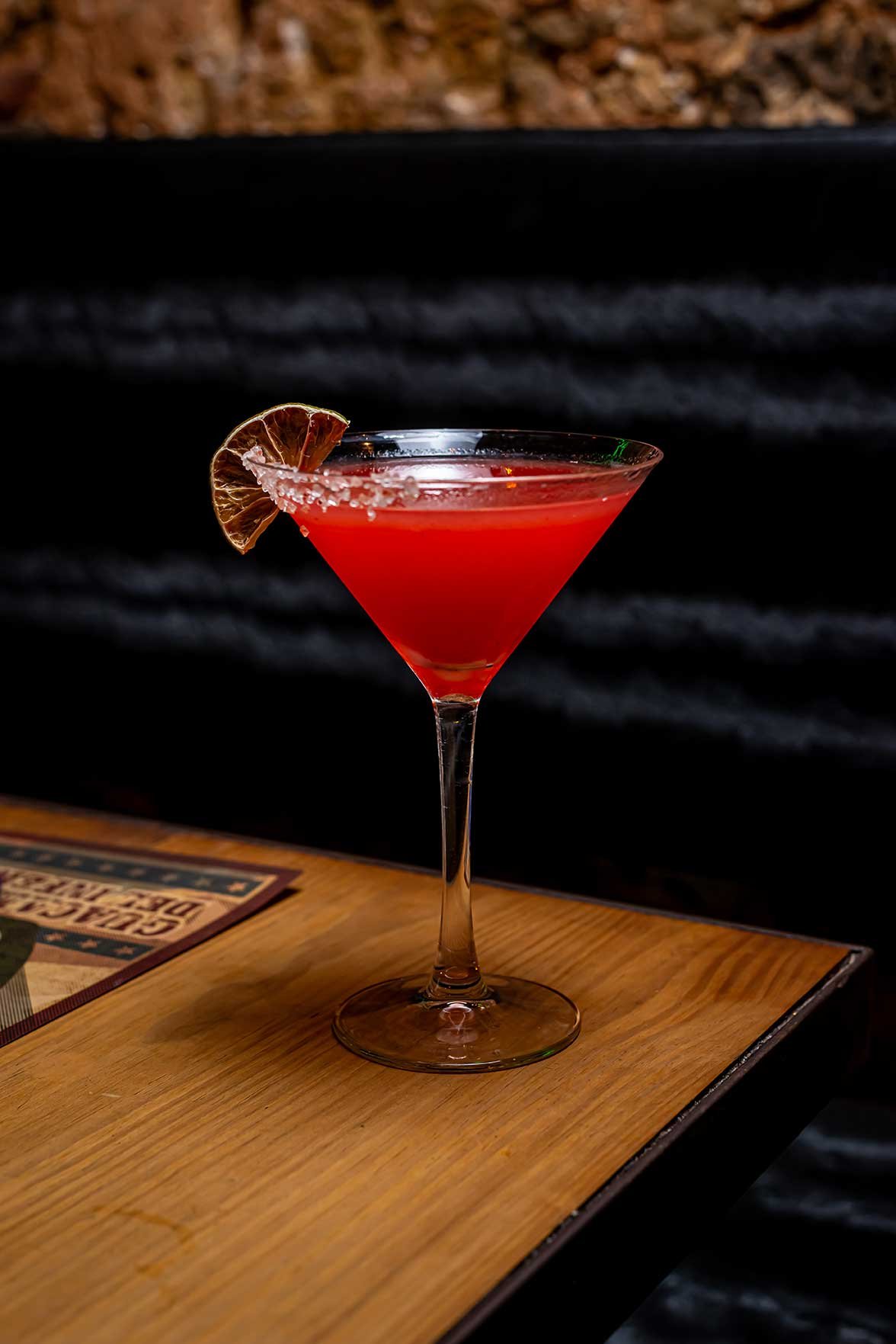 A red cocktail in a martini glass